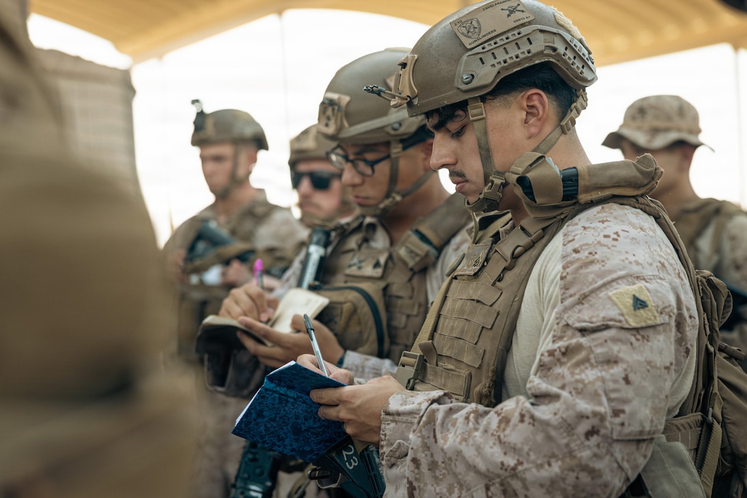 U.S. Marines take notes during a convoy brief before departing to a Position Area for Artillery in the U.S. Central Command area of responsibility, June 16, 2026. Maneuvering to a PAA allows Marine Corps artillery batteries to deliver rapid, long-range fire support to ground and maneuver forces in a designated area of responsibility. (U.S. Marine Corps photo by Sgt. Antonino Mazzamuto)