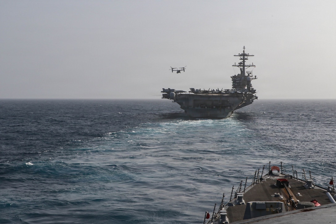 Arleigh Burke-class guided-missile destroyer USS Frank E. Petersen Jr. (DDG 121) sails behind the Nimitz-class aircraft carrier USS Abraham Lincoln (CVN 72), June 27, 2026. Frank E. Petersen Jr. is deployed to the U.S. 5th Fleet area of operations to support maritime security and stability in the Middle East. (U.S. Navy photo)