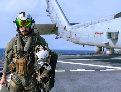U.S. Sailor leaves an MH-60R Sea Hawk, attached to Helicopter Maritime Strike Squadron (HSM) 71, on the flight deck of Arleigh Burke-class guided-missile destroyer USS Milius (DDG 69) during flight operations, June 27, 2026. Milius is deployed to the U.S. 5th Fleet area of operations to support maritime security and stability in the Middle East. (U.S. Navy photo)
