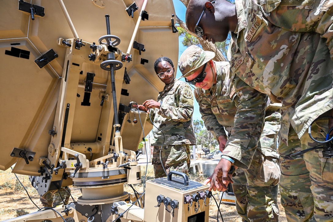 U.S. Airmen wire and test a satellite communications dish at a base in the U.S. Central Command area of responsibility June 12, 2026. (U.S. Air Force photo by Staff Sgt. Justin W. Moore)