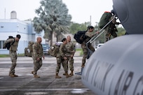 U.S. Airmen with the 156th Contingency Response Group board a C-17 Globemaster III assigned to the 105th Airlift Wing, New York Air National Guard, at Muñiz Air National Guard Base, Carolina, Puerto Rico, Jan. 31, 2025.