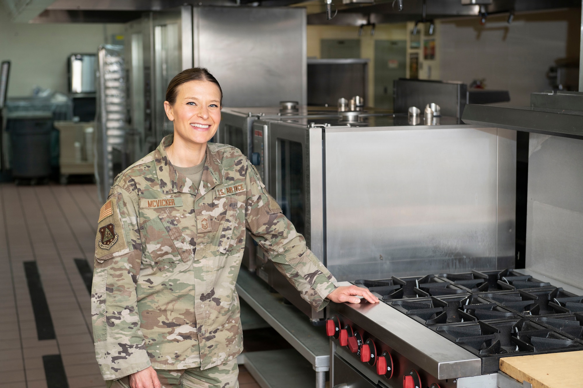Woman stands by stove