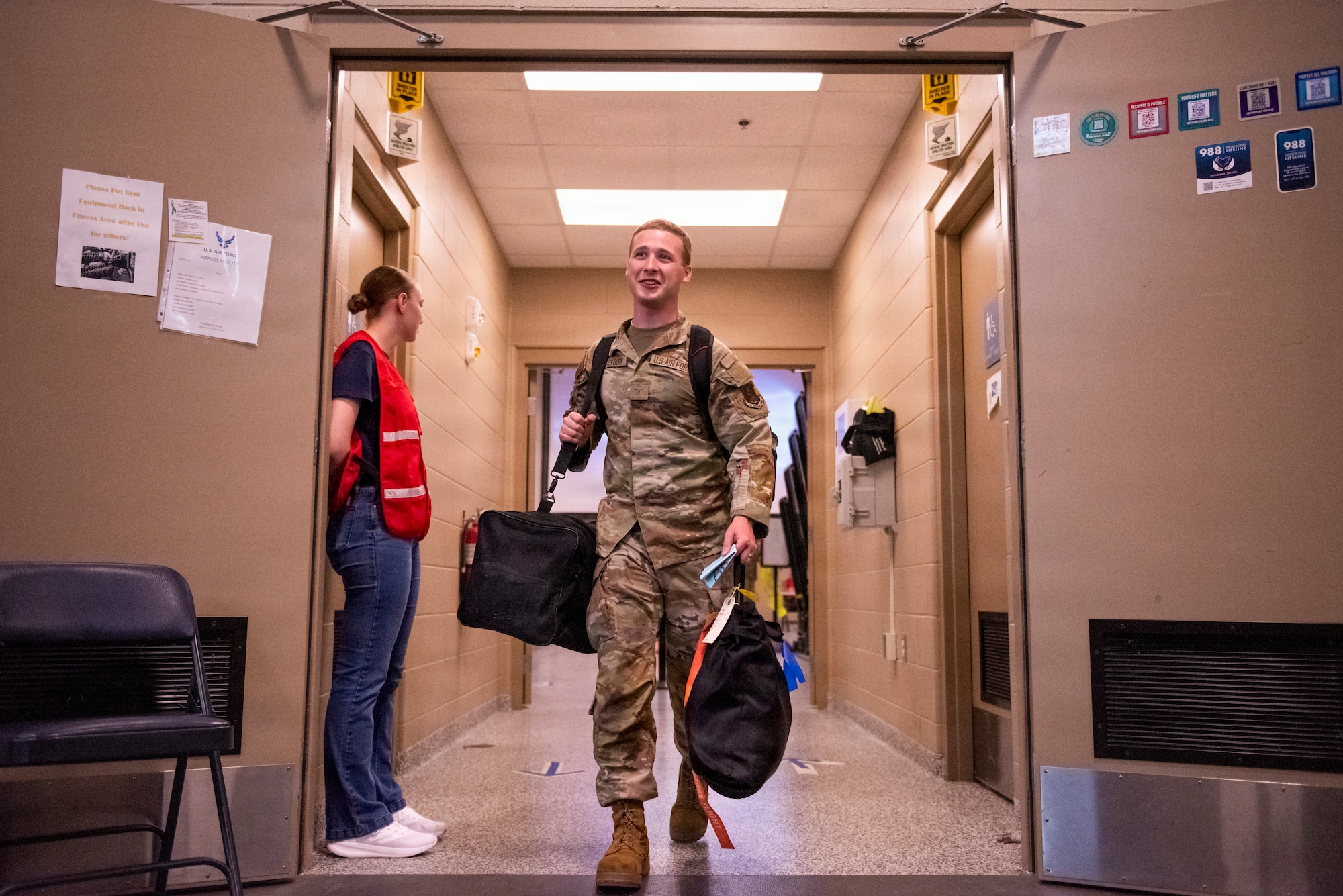 man walks through hall with luggage