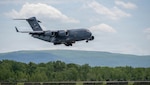 A C-17 Globemaster III lowers its landing gear as it prepares to land at Stewart Air National Guard Base, New York, May 20, 2026. A C-17 from the 105th Airlift Wing will take part in the July 4 International Aerial Review which will start over Staten Island and finish up over the Mario M. Cuomo Bridge on the Tappan Zee section of the Hudson River. Photo by Airman Anthony Wilson.