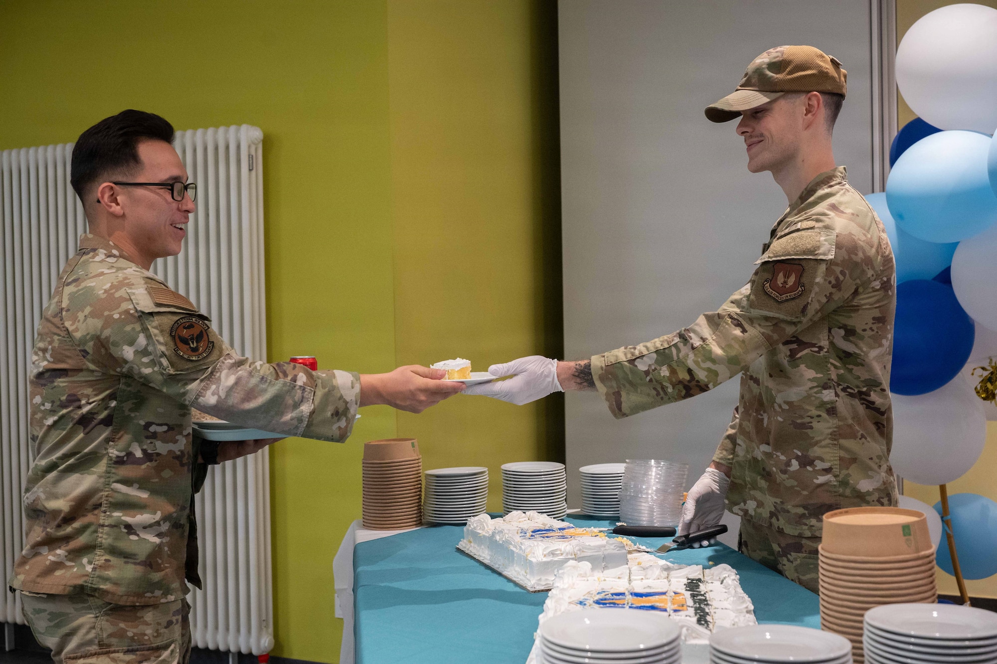 A photo of Airmen sharing a plate of cake