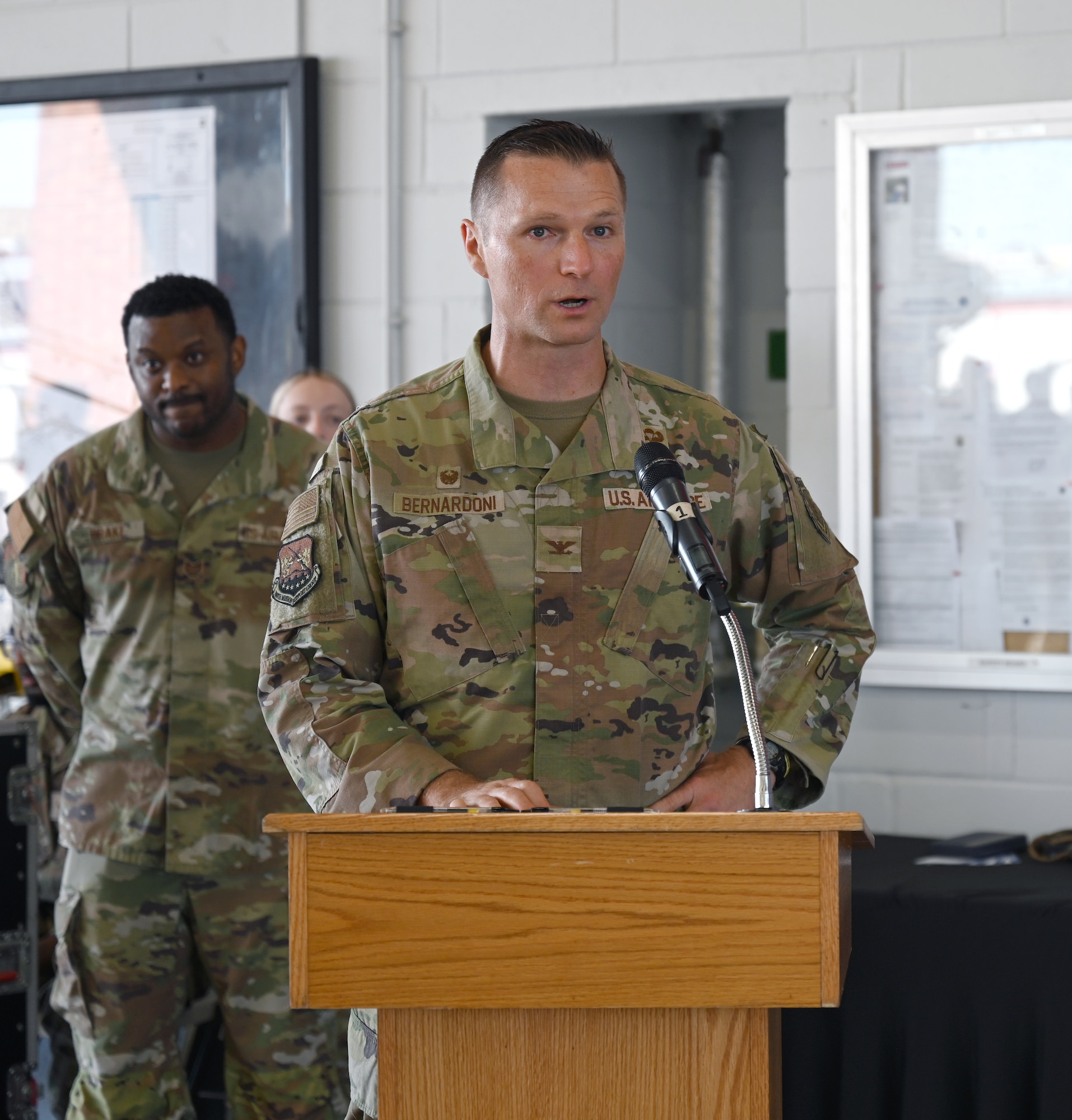 U.S. Air Force Col. Brandon Bernardoni, 100th Mission Support Group commander, gives his opening remarks to the audience and members of the 100th MSG at the change of command ceremony at RAF Mildenhall, England, June 26, 2026. The change of command ceremony is a time-honored tradition in which one officer relinquishes command and passes it to another. (U.S. Air Force photo by Karen Abeyasekere)
