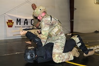 U.S. Army Soldiers participating in the Pennsylvania National Guard State Combatives Program's Basic Combatives Course demonstrate close-quarters combat techniques during the course's culminating training event at Fort Indiantown Gap, Pennsylvania, June 26, 2026. Throughout the 40-hour course, Soldiers developed foundational hand-to-hand combat skills through realistic, hands-on training. (U.S. Army National Guard photo by Sgt. 1st Class Shane Smith)