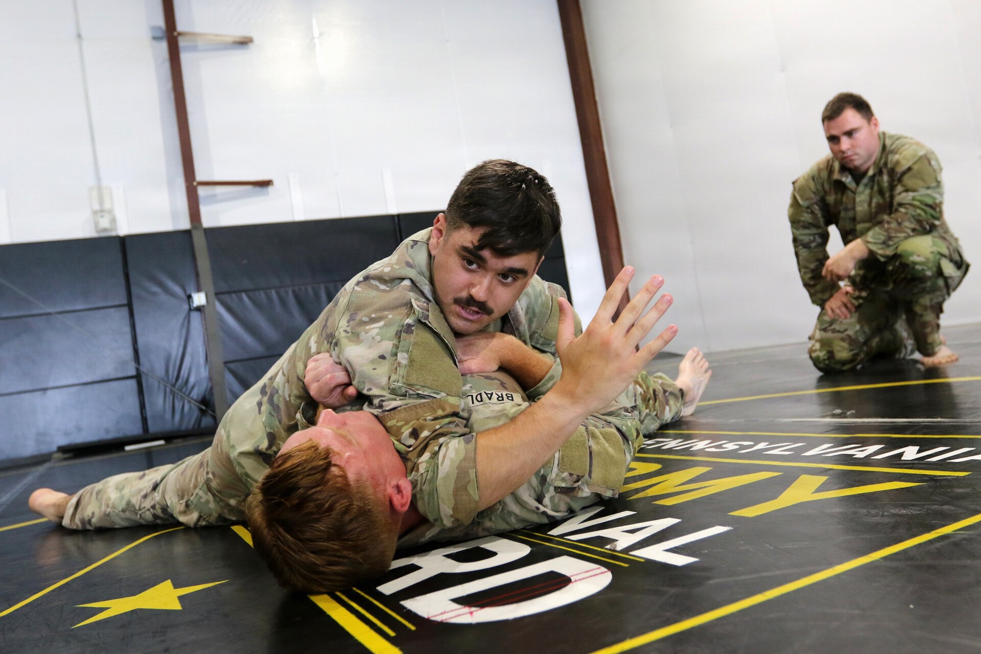 U.S. Army Soldiers participating in the Pennsylvania National Guard State Combatives Program's Basic Combatives Course demonstrate close-quarters combat techniques during the course's culminating training event at Fort Indiantown Gap, Pennsylvania, June 26, 2026. Throughout the 40-hour course, Soldiers developed foundational hand-to-hand combat skills through realistic, hands-on training. (U.S. Army National Guard photo by Sgt. 1st Class Shane Smith)