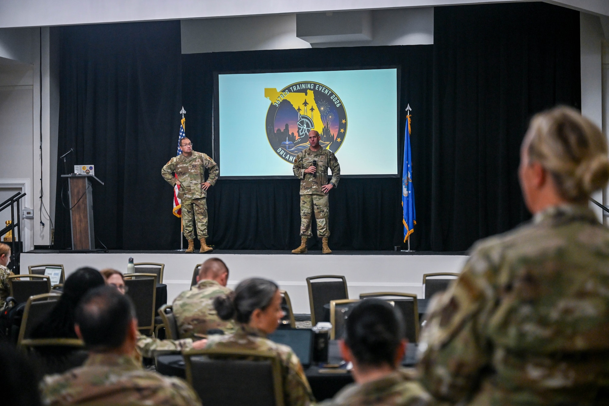 367th Recruiting Group leadership, Col. Sean "Metro" Fellows, 367 RCG commander, and Chief Master Sgt. Derek Hudson, 367 RCG senior enlisted leader, Robins Air Force Base, Georgia, discuss recruiting training on officer accessions, health professions, and 367 RCG group staff at the Group Training Event held June 8-11, 2026, in Orlando, Florida. (U.S. Air Force photo by Master Sgt. Della Creech)