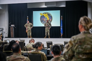 367th Recruiting Group leadership, Col. Sean "Metro" Fellows, 367 RCG commander, and Chief Master Sgt. Derek Hudson, 367 RCG senior enlisted leader, Robins Air Force Base, Georgia, discuss recruiting training on officer accessions, health professions, and 367 RCG group staff at the Group Training Event held June 8-11, 2026, in Orlando, Florida. (U.S. Air Force photo by Master Sgt. Della Creech)