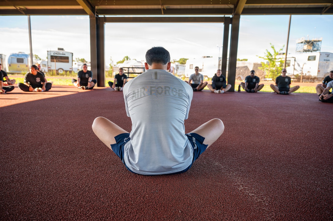 U.S. Air Force Senior Airman Havin O’Dell, defender assigned to the 316th Security Forces Group leads cooldown stretches.