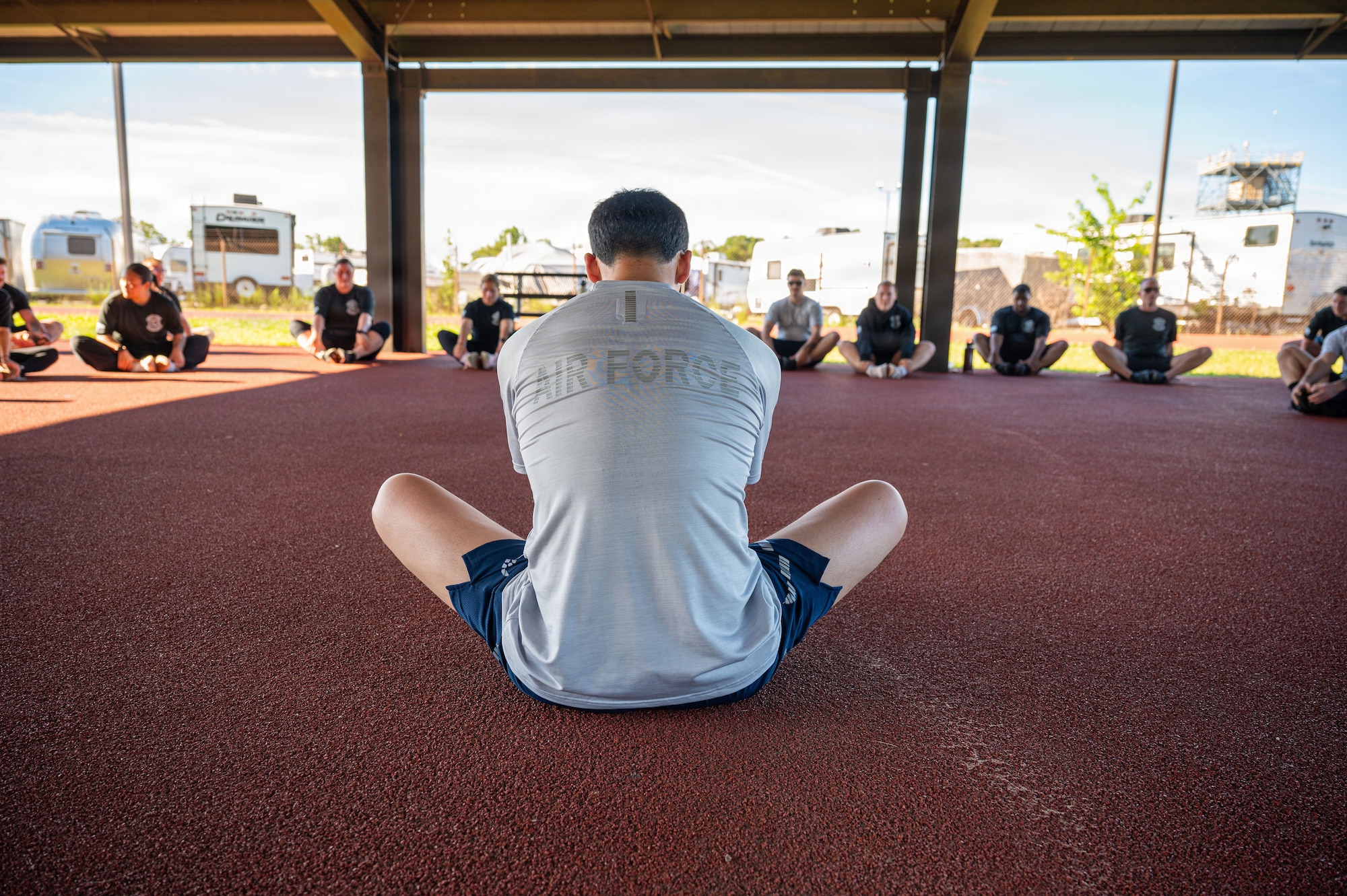U.S. Air Force Senior Airman Havin O’Dell, defender assigned to the 316th Security Forces Group leads cooldown stretches.