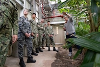 Allen O’Hara, facility manager for the U.S. Naval Research Laboratory's (NRL) Laboratory for Autonomous Systems Research (LASR), leads midshipmen from the U.S. Naval Academy Physics Club on a tour of NRL’s Tropical High Bay in Washington, March 25, 2026. The unique facility allows researchers to test new technology against real-world environmental conditions, ensuring naval systems are reliable and ready for deployment. (U.S. Navy photo by Sarah Peterson) RELEASED