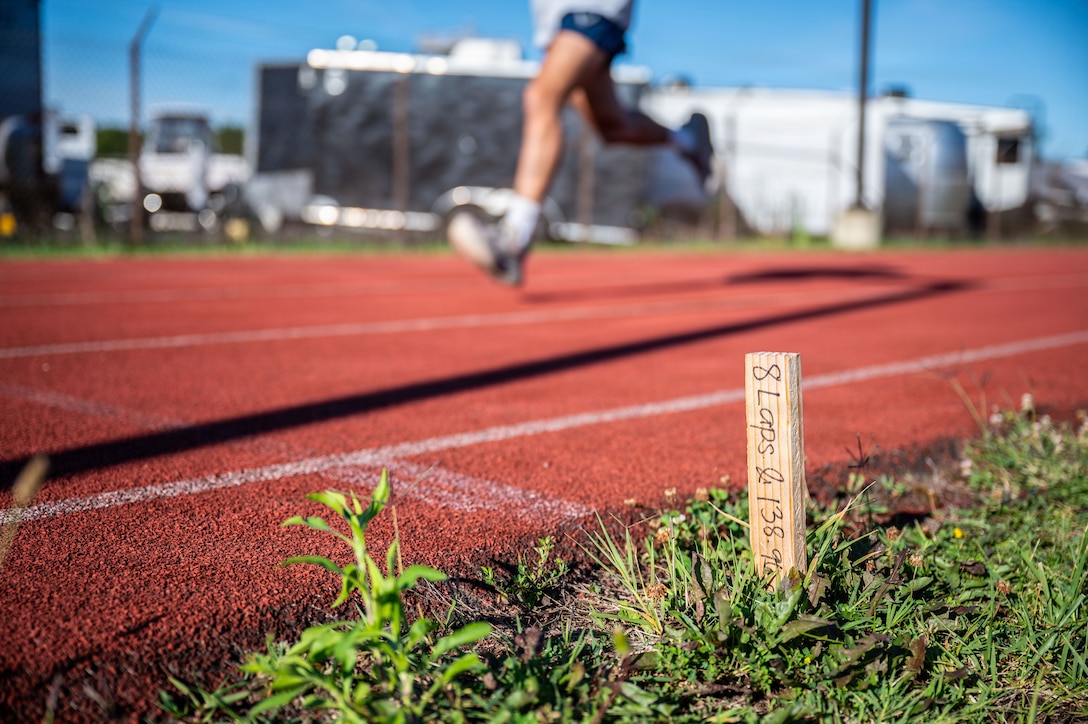 A U.S. Airman assigned to the 316th Security Forces Group runs laps around the track during physical training.