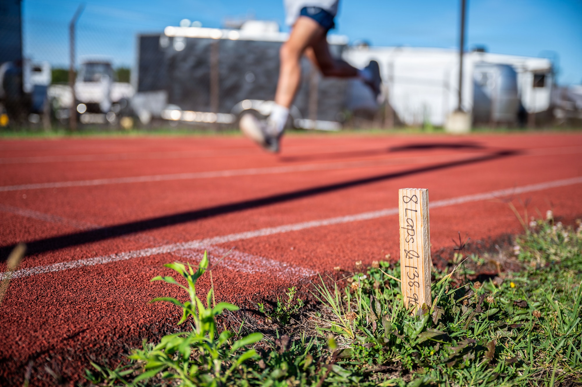 A U.S. Airman assigned to the 316th Security Forces Group runs laps around the track during physical training.
