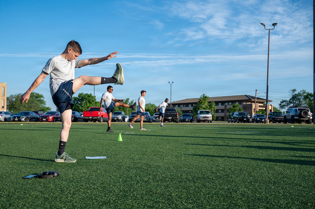 U.S. Airmen, unit fitness leaders assigned to the 316th Civil Engineer Squadron conduct stretches before a unit 5K.