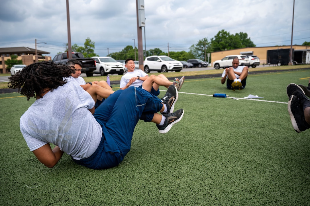 U.S. Airmen assigned to the 316th Force Support Squadron perform core exercises as part of their group physical training.