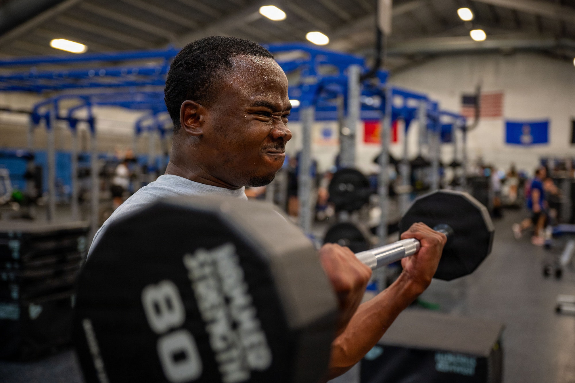 U.S. Air Force Senior Airman Austin Mwandoe, financial operations technician assigned to the 316th Comptroller Squadron, performs an arm curl.