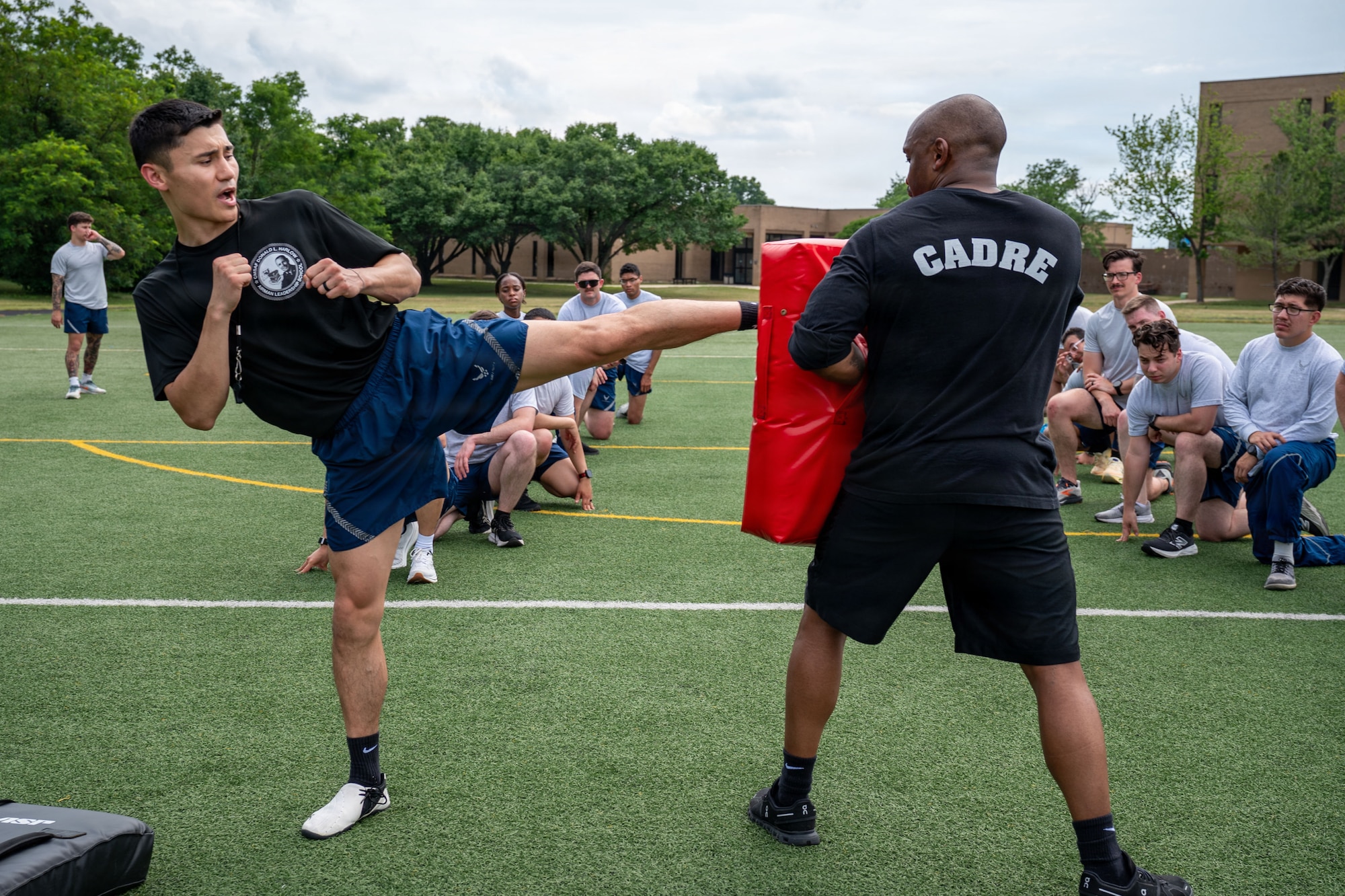 U.S. Air Force Staff Sgt. Brandon Fletcher, left, Airman Leadership School instructor assigned to the 316th Force Support Squadron, and Tech. Sgt. LaMorris McRae, medical information system section chief assigned to the Bolling Medical Squadron, demonstrate proper form during a martial arts lesson.