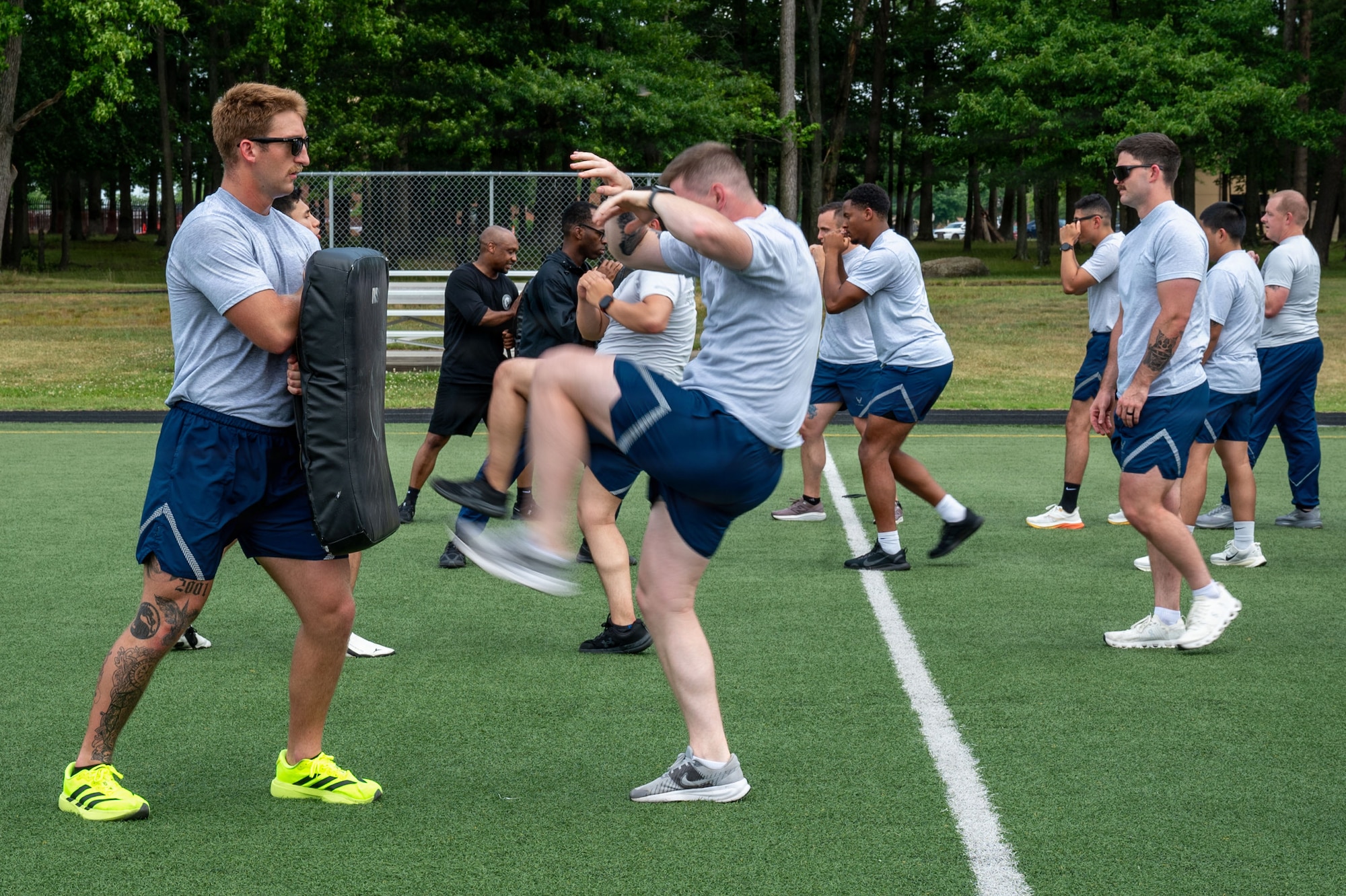 U.S. Airmen with the Donald L. Harlow Airman Leadership School learn martial arts during physical training.