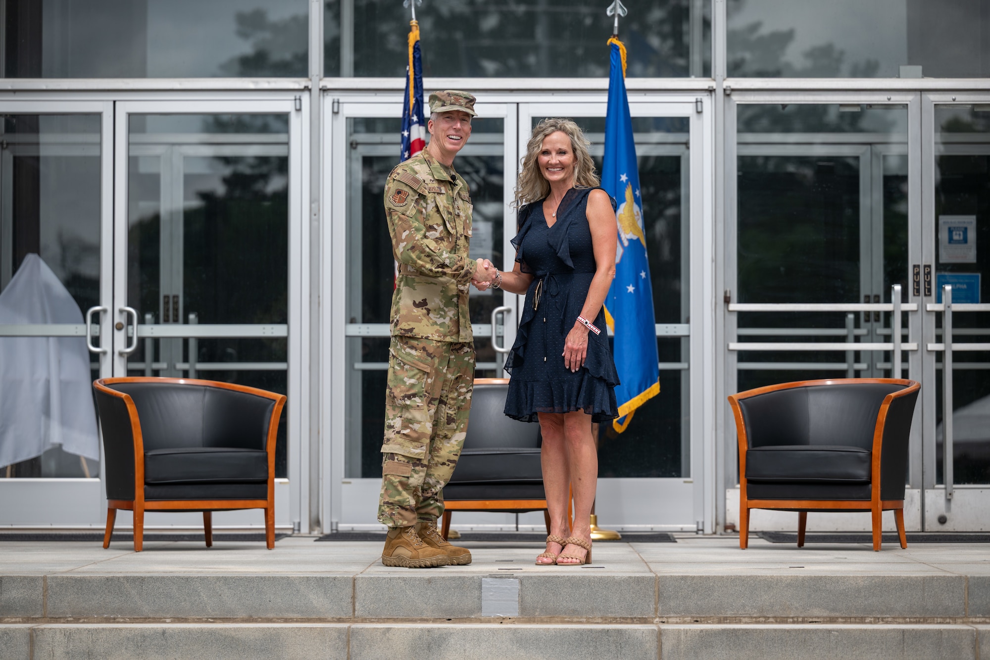 April Norris, Tullahoma City Schools superintendent, shakes hands with outgoing Arnold Engineering Development Complex Commander Col. Grant Mizell during the Arnold Air Force Base Honorary Commanders induction ceremony June 27, 2026, at Arnold AFB, Tenn., headquarters of AEDC. Norris was selected as the Honorary Commander representing AEDC. The Honorary Commanders were inducted during the AEDC 75th anniversary open house celebration at Arnold AFB. (U.S. Air Force photo by Keith Thornburgh)