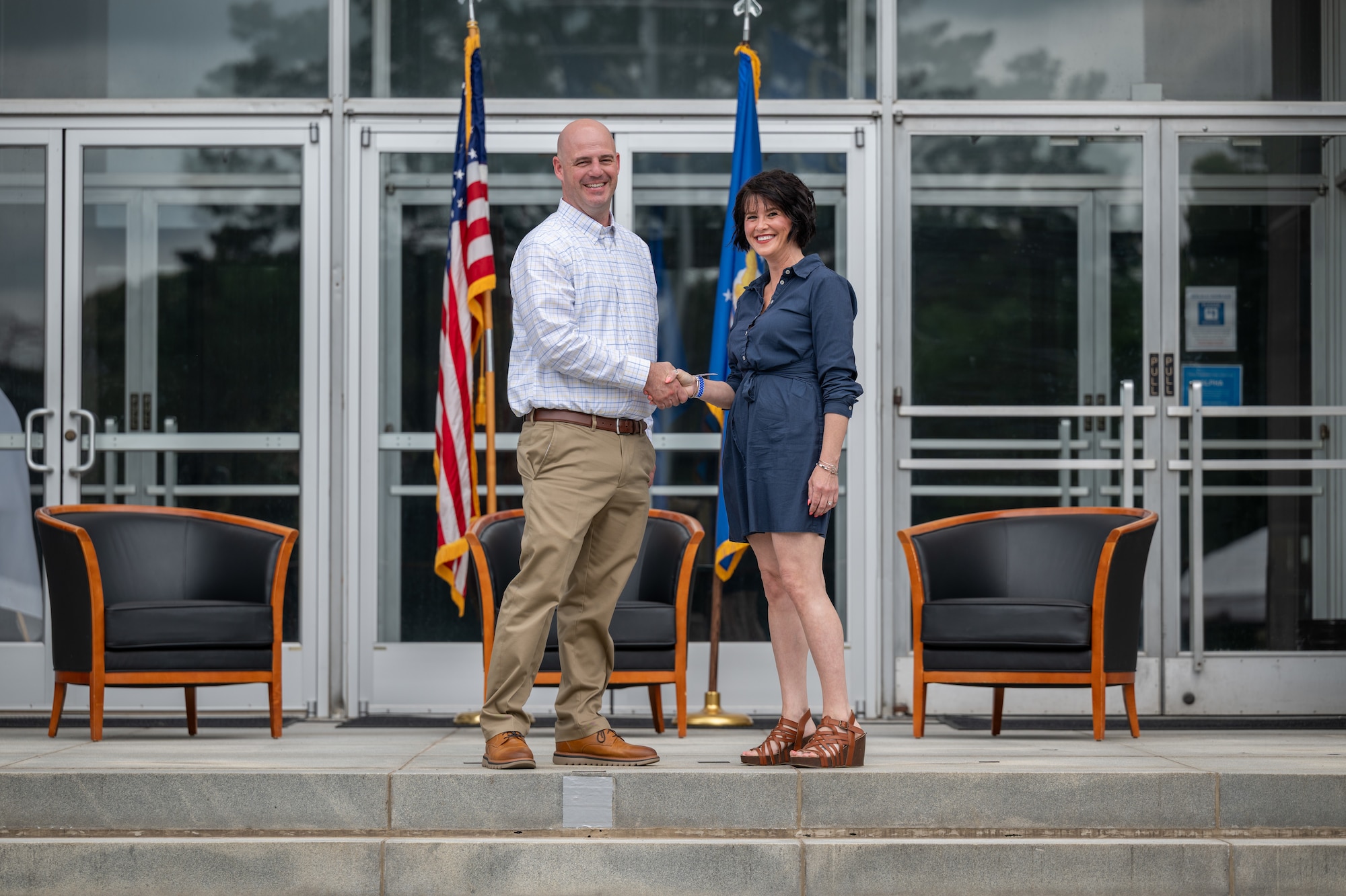 Kelly North, Tullahoma Area Economic Development Corporation executive director, shakes hands with 804th Test Support Squadron Director Dustin Boss during the Arnold Air Force Base Honorary Commanders induction ceremony June 27, 2026, at Arnold AFB, Tenn., headquarters of Arnold Engineering Development Complex. North was selected as the Honorary Commander representing the 804 TSS. The Honorary Commanders were inducted during the AEDC 75th anniversary open house celebration at Arnold AFB. (U.S. Air Force photo by Keith Thornburgh)