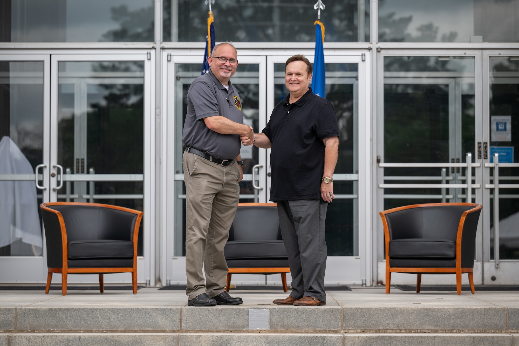 Greg Gressel, South Jackson Performing Arts Center & Tullahoma Fine Arts Center executive director and chairman, right, shakes hands with 715th Test Squadron Director Jeffrey Staines during the Arnold Air Force Base Honorary Commanders induction ceremony June 27, 2026, at Arnold AFB, Tenn., headquarters of Arnold Engineering Development Complex. Gressel was selected as the Honorary Commander representing the 715 TS. The Honorary Commanders were inducted during the AEDC 75th anniversary open house celebration at Arnold AFB. (U.S. Air Force photo by Keith Thornburgh)