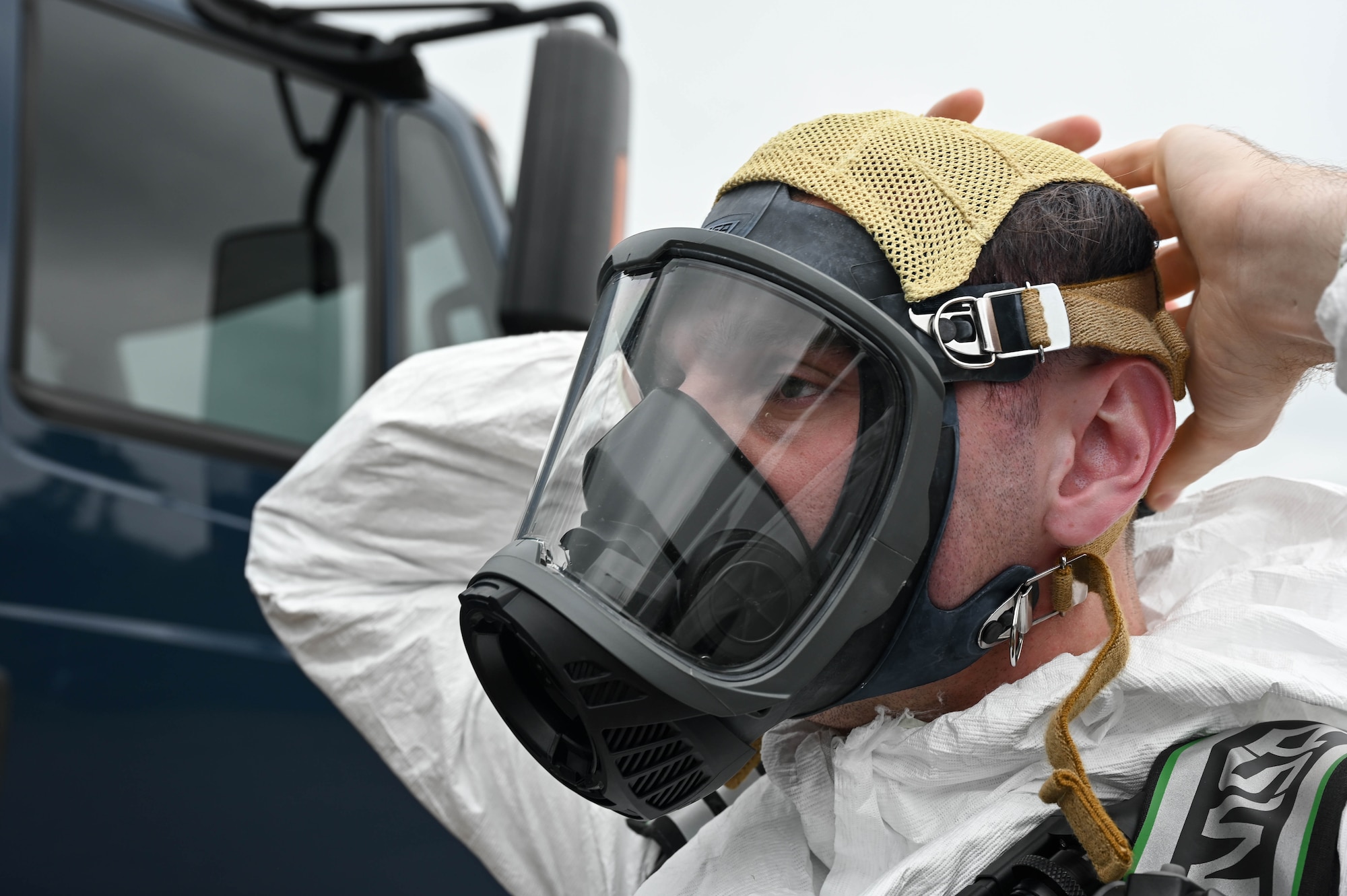 A man puts on a gas mask