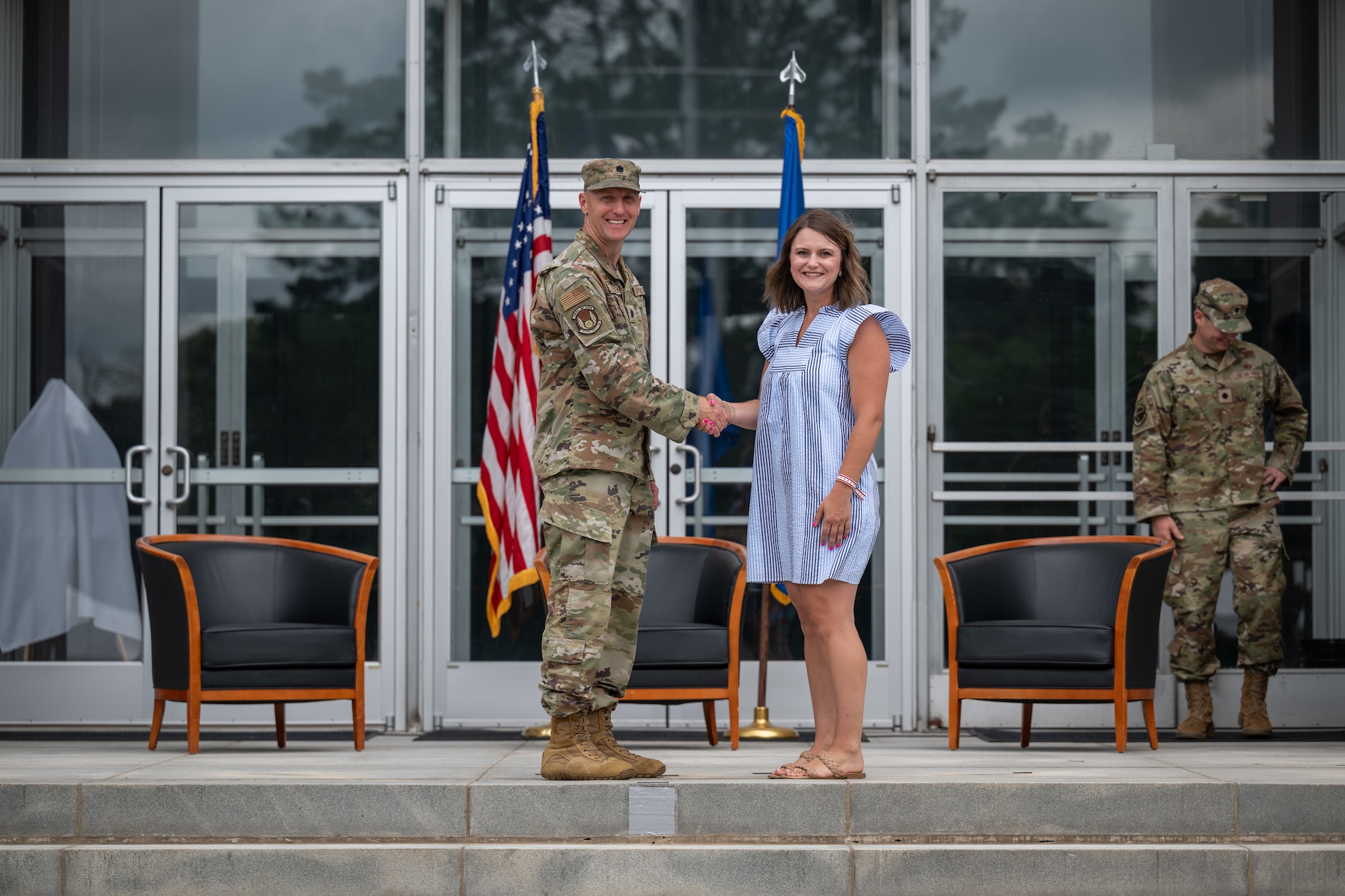 Rachel Shields, Franklin County Schools secondary supervisor, shakes hands with 717th Test Squadron Commander Lt. Col. Jonathan Tellefsen during the Arnold Air Force Base Honorary Commanders induction ceremony June 27, 2026, at Arnold AFB, Tenn., headquarters of Arnold Engineering Development Complex. Shields was selected as the Honorary Commander representing the 717 TS. The Honorary Commanders were inducted during the AEDC 75th anniversary open house celebration at Arnold AFB. (U.S. Air Force photo by Keith Thornburgh)