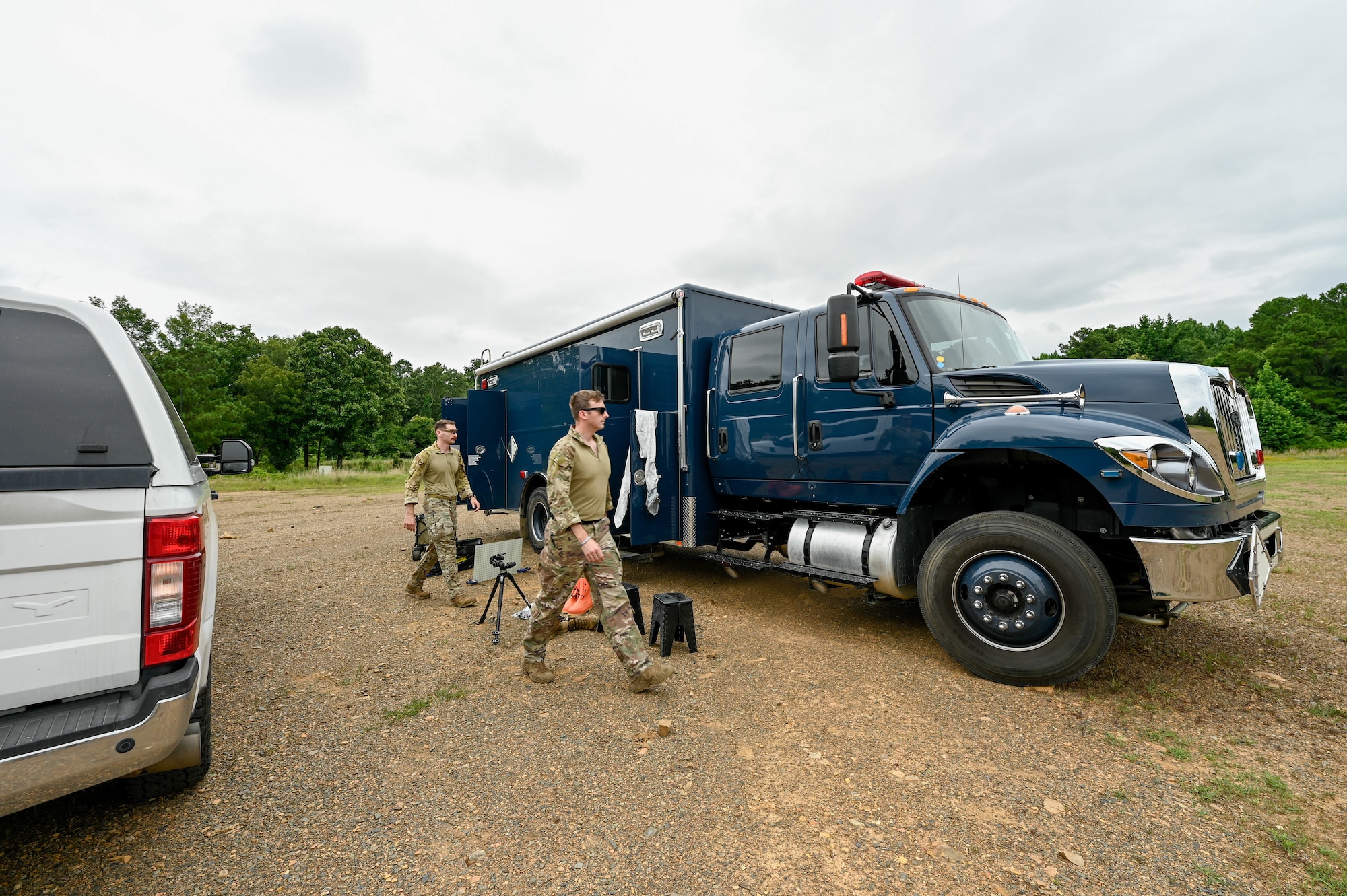 Two men stand outside of truck