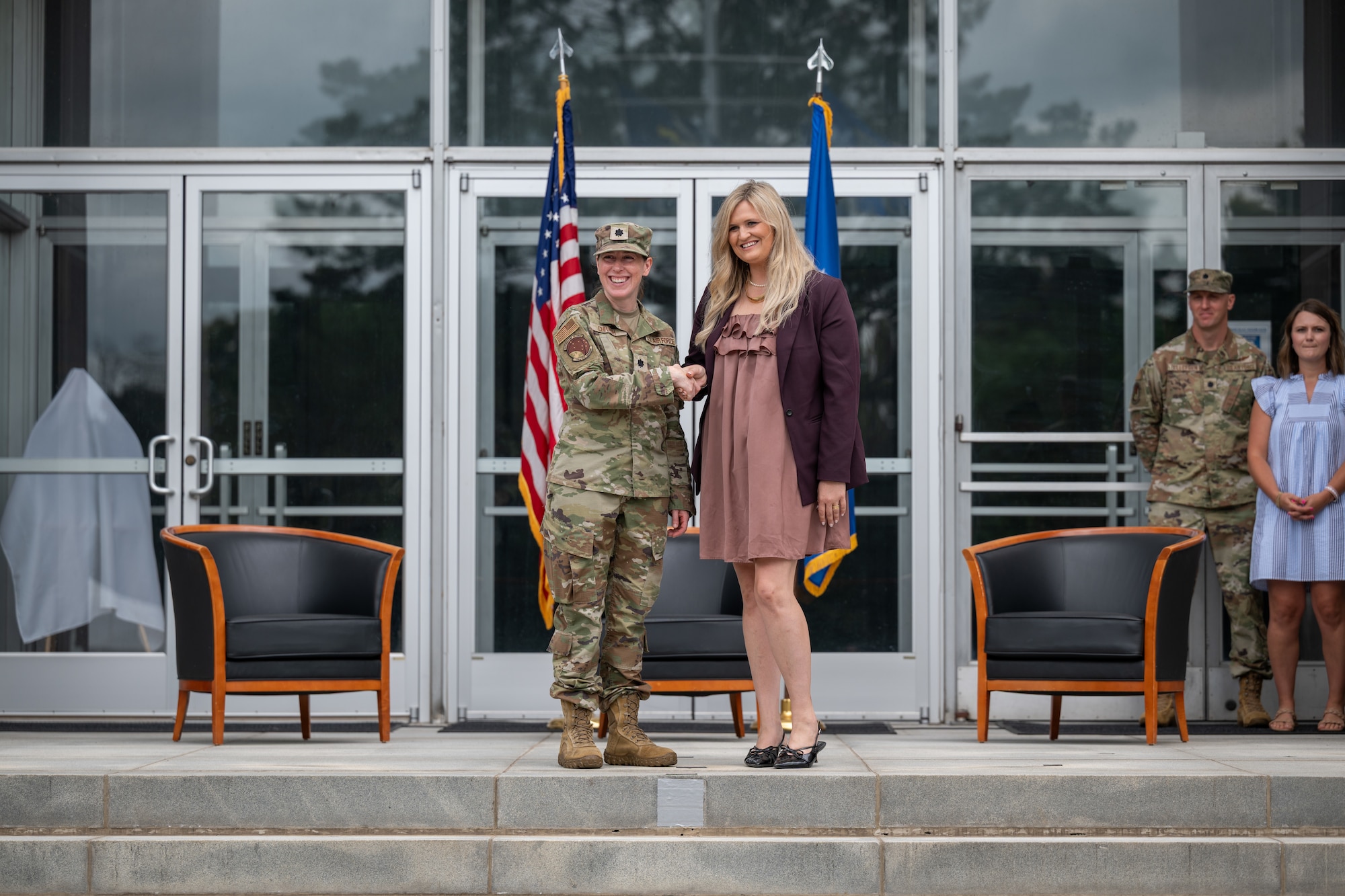 Ashley Gibbs, United Way of South Central Tennessee regional director, shakes hands with 718th Test Squadron Commander Lt. Col. Rachel Chrash during the Arnold Air Force Base Honorary Commanders induction ceremony June 27, 2026, at Arnold AFB, Tenn., headquarters of Arnold Engineering Development Complex. Gibbs was selected as the Honorary Commander representing the 718 TS. The Honorary Commanders were inducted during the AEDC 75th anniversary open house celebration at Arnold AFB. (U.S. Air Force photo by Keith Thornburgh)