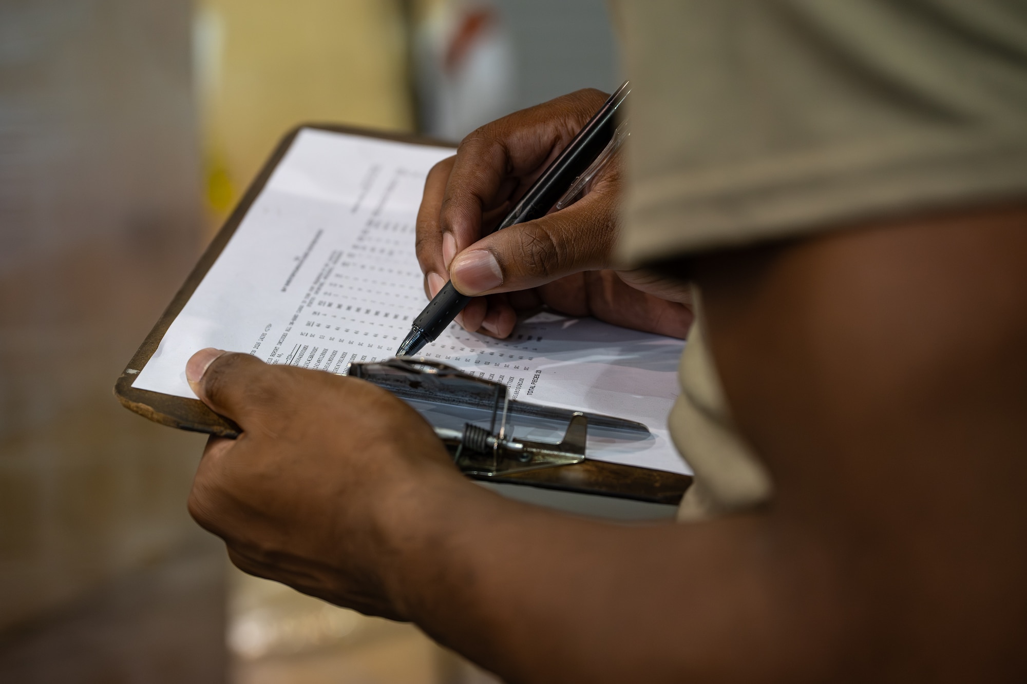 U.S. Air Force Airman Clark Bote, 436th Aerial Port Squadron processor, uses a clipboard to document the items being packaged in a pallet on Dover Air Force Base, Delaware, June 24, 2026.