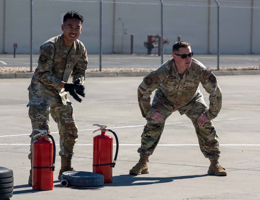 Airmen are getting ready to partake in a relay race.