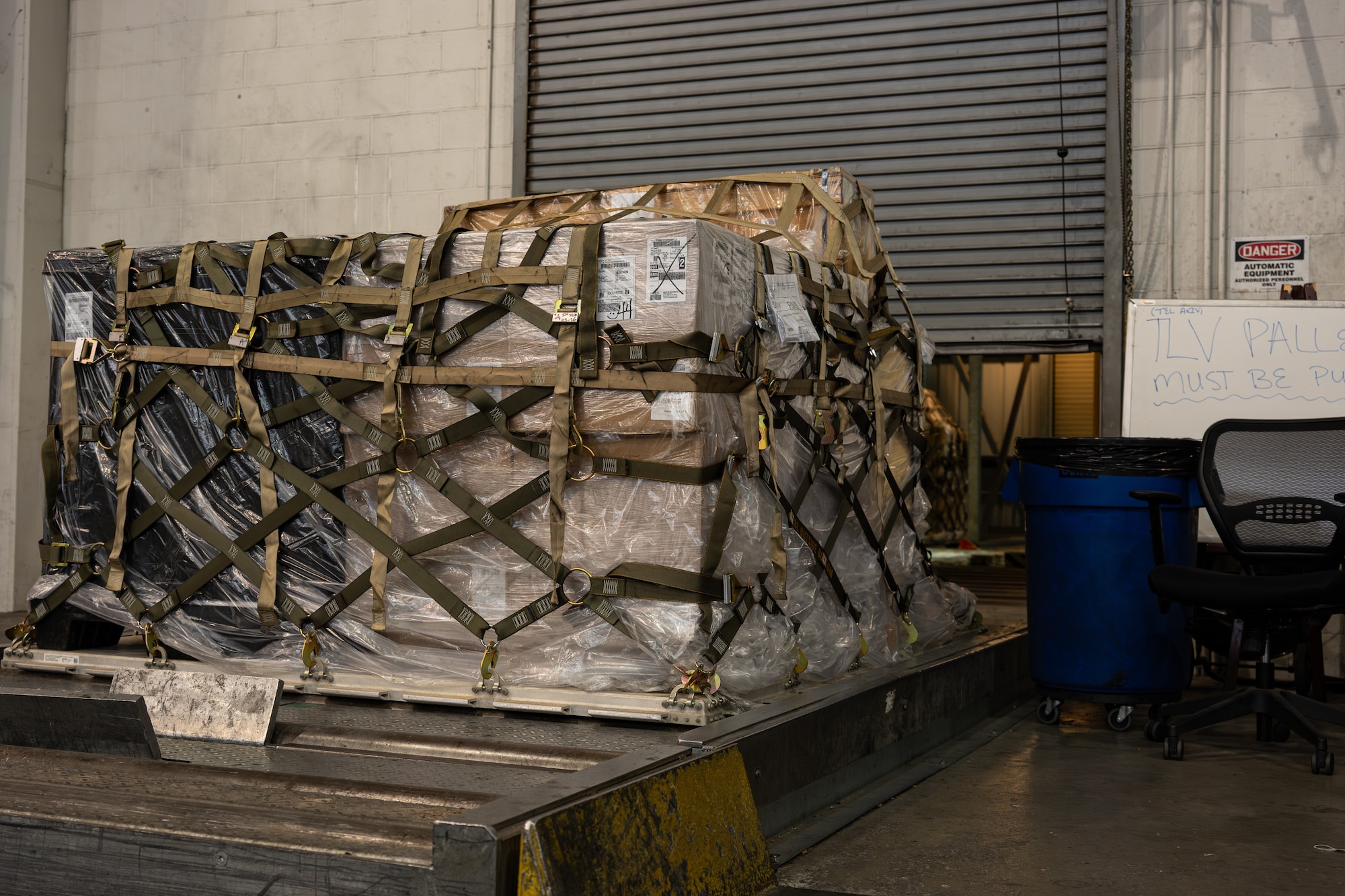 Cargo pallets are rolled into the storage area before being loaded onto an aircraft on Dover Air Force Base, Delaware, June 24, 2026.