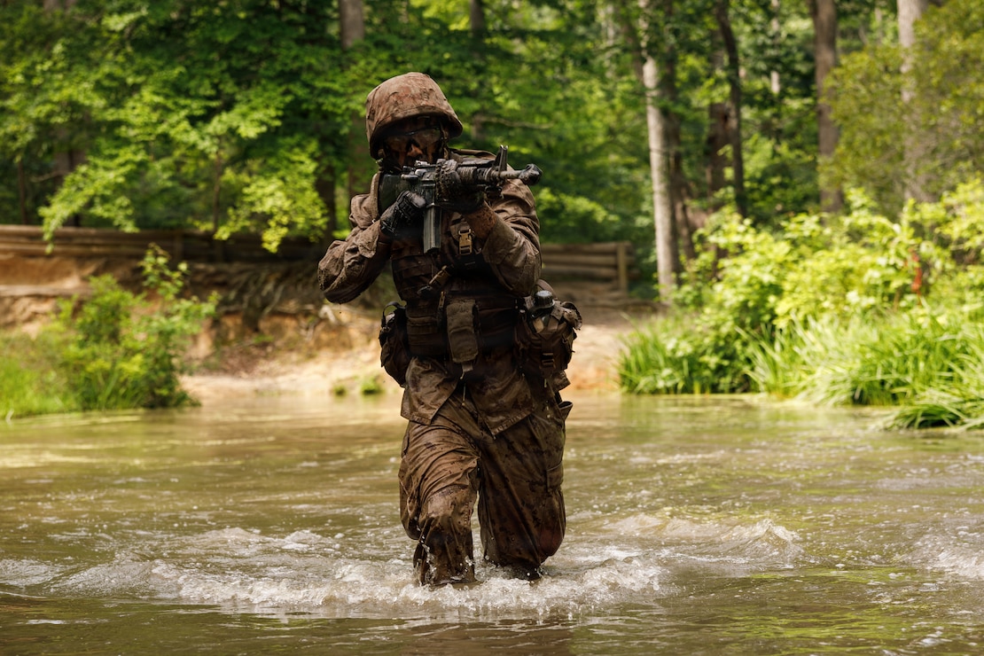 A U.S. Marine Corps officer candidate with Platoon Leaders Course Juniors, India Company, Officer Candidates School, participates in the combat course at Marine Corps Base Quantico, Virginia, June 22, 2026. The combat course challenges candidates with obstacles and combat oriented scenarios to allow candidates to demonstrate physical fitness, mental resilience, and tactical decision-making skills. (U.S. Marine Corps photo by Cpl. Joshua Barker)