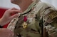 U.S. Air Force Col. Michael Suden, 91st Operations Group outgoing commander, receives the Legion of Merit medal during a change of command ceremony at Minot Air Force Base, North Dakota, June 24, 2026.