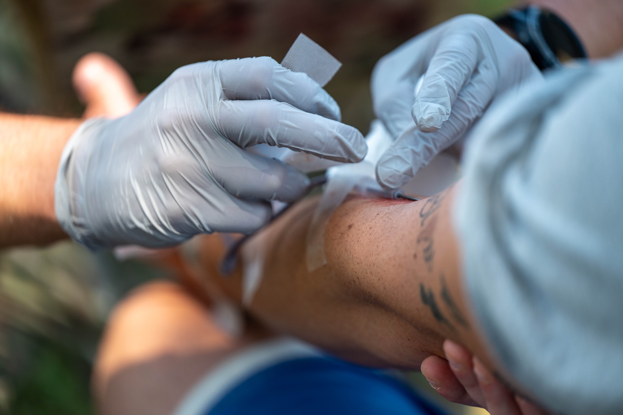 An Air Commando assigned to the 1st Special Operations Wing draws blood on a volunteer