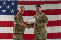 U.S. Air Force Col. Jimmy Schlabach, 91st Missile Wing commander (left), presents the Legion of Merit to Col. Michael Suden, 91st Operations Group outgoing commander, during a change of command ceremony at Minot Air Force Base, North Dakota, June 24, 2026.
