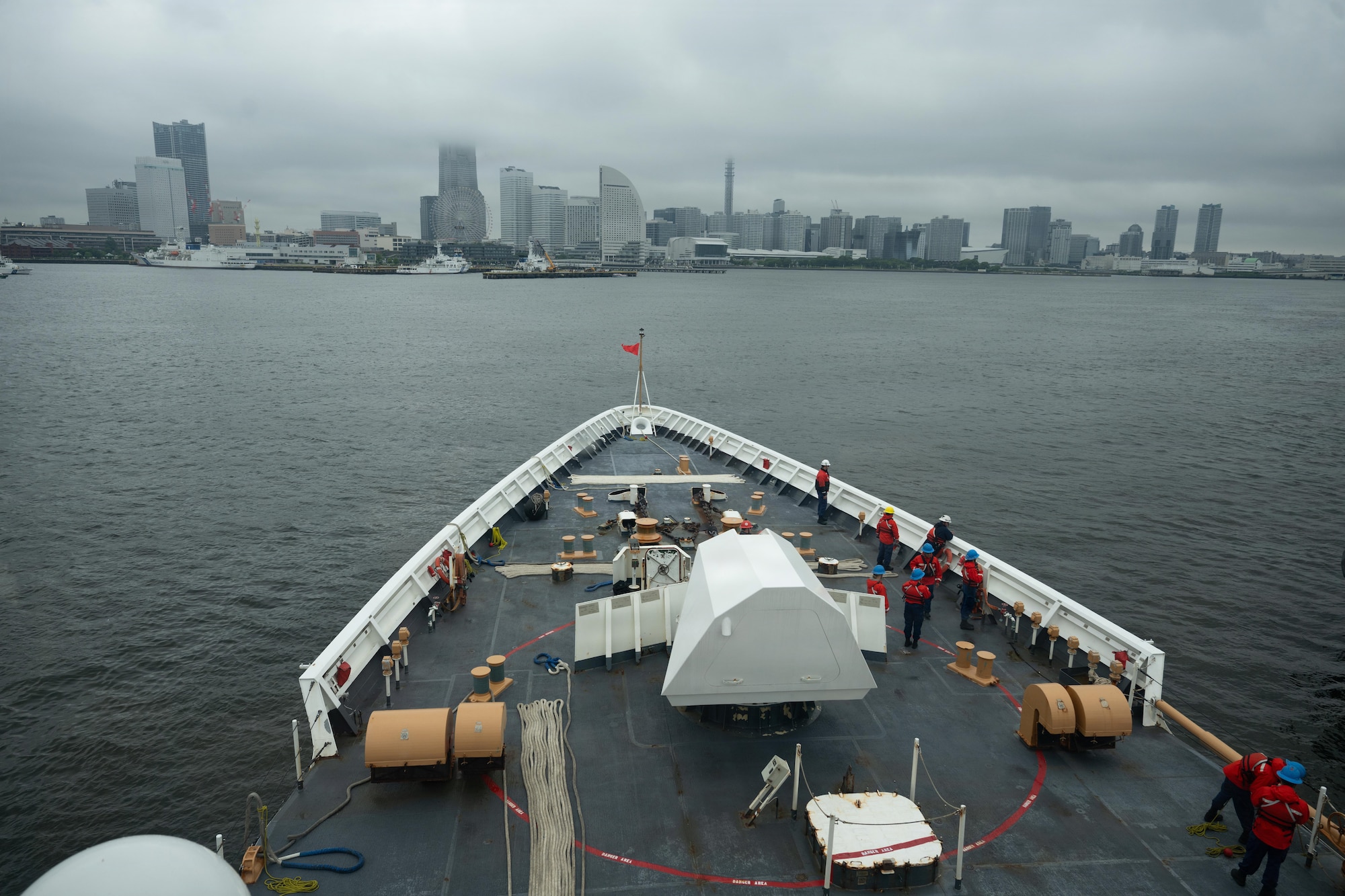 Crew members assigned to Legend-class cutter USCGC Midgett (WMSL 757) prepare the forecastle for mooring operations in Yokohama, Japan, during Pacific Atlas, June 18, 2026. Pacific Atlas is a series of demonstrations of allied logistics interoperability, signaling collective capability to sustain distributed maritime operations in the region. (U.S. Coast Guard Photo by Petty Officer 3rd Class Austin Wiley)