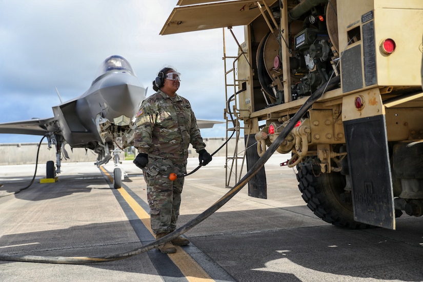 U.S. Army Reserve Sgt. Soonafai Seloti, assigned to the Forward Support Company, 411th Engineer Battalion, 303rd Maneuver Enhancement Brigade, 9th Mission Support Command, prepares to begin refueling a U.S. Air Force F-35 Lightning II assigned to the 4th Expeditionary Fighter Squadron using a U.S. Army Heavy Expanded Mobility Tactical Truck during Exercise Valiant Shield 2026 at Andersen Air Force Base, Guam, June 22, 2026.