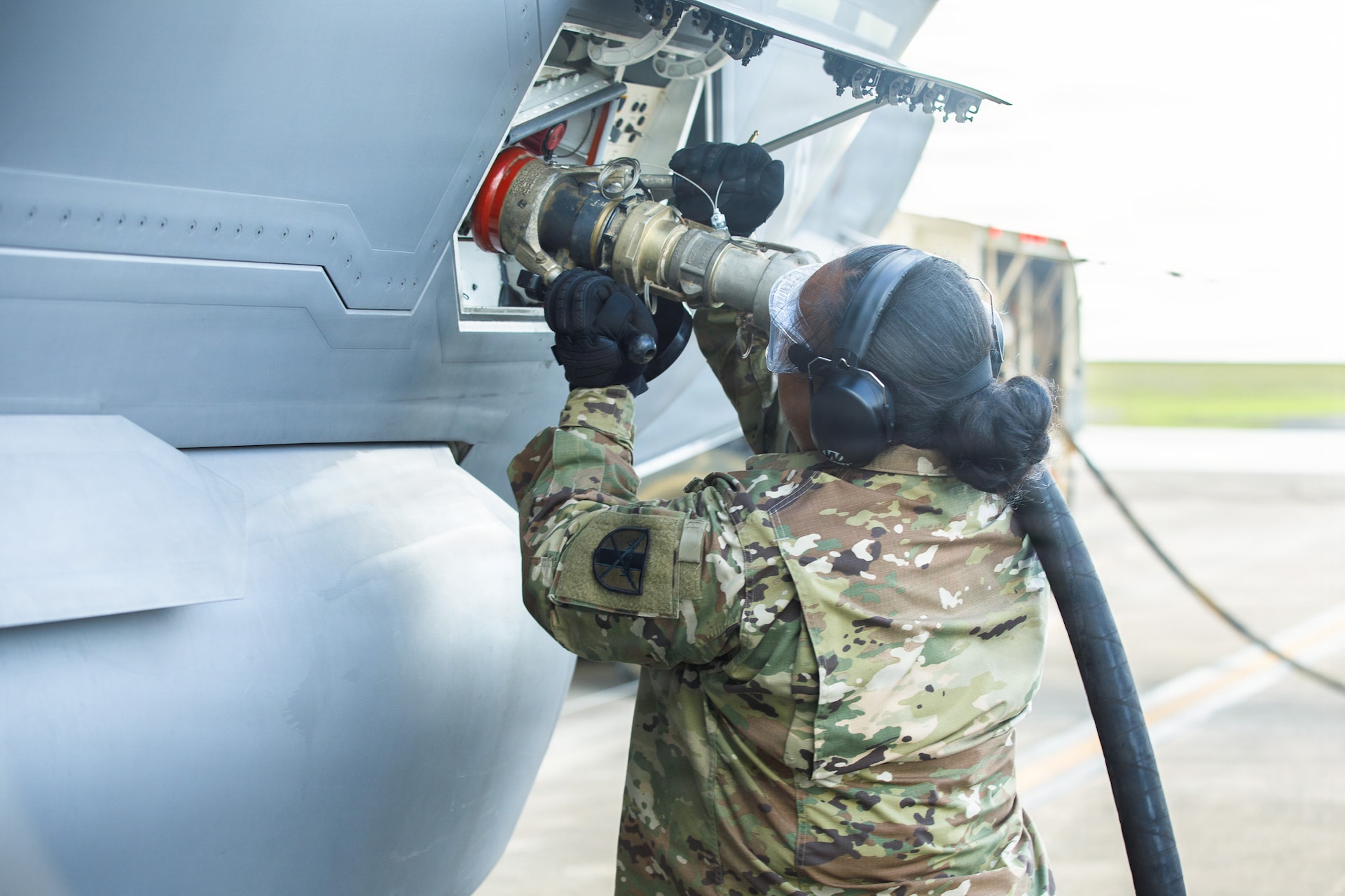 U.S. Army Reserve Sgt. Soonafai Seloti, Forward Support Company 411th Engineer Battalion, 303rd Maneuver Enhancement Brigade, 9th Mission Support Command, connects the fuel hose of a U.S. Army Heavy Expanded Mobility Tactical Truck to refuel a U.S. Air Force F-35 Lightning II, 4th Expeditionary Fighter Squadron, June 22, 2026, at Anderson Air Force Base, Guam, as part of exercise Valiant Shield 2026.