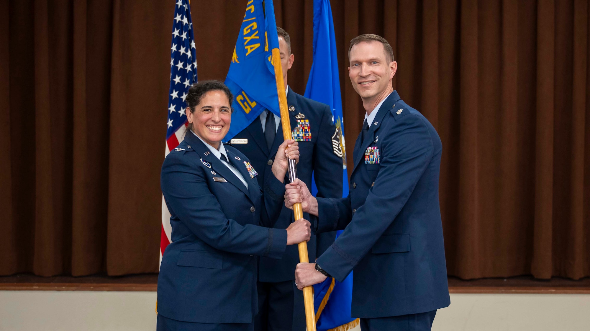 Lt. Col. Jonathan Garver, right assumes command of the squadron from Col. Paola Ondina.