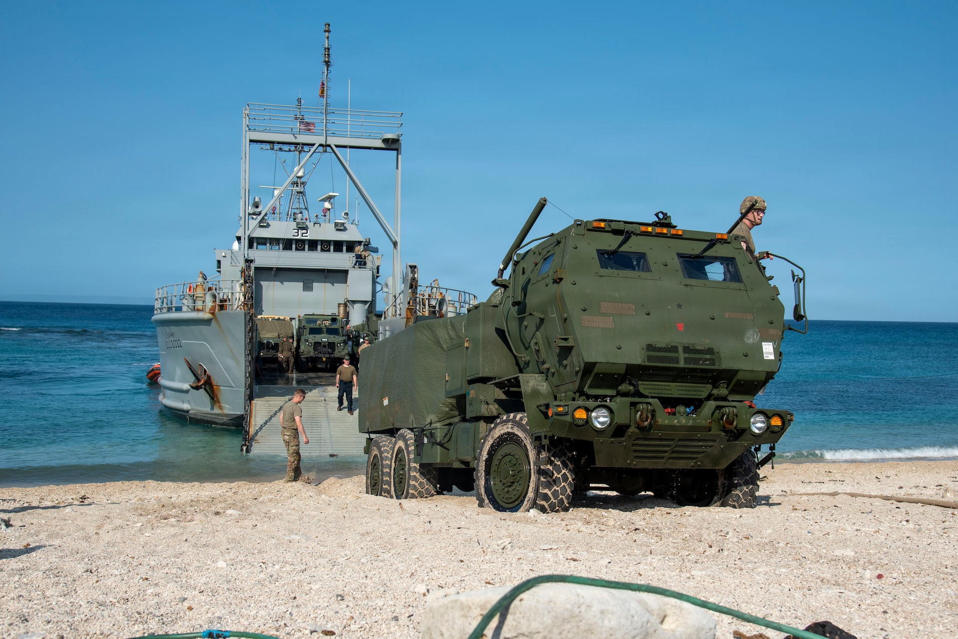 U.S. Marines with 3rd Littoral Combat Team, 3rd Marine Littoral Regiment, 3rd Marine Division, and U.S. Army Soldiers with 7th Infantry Division, Multi-Domain Command - Pacific, guide an M142 High Mobility Artillery Rocket System off a U.S. Army Landing Craft Utility during a ship-to-shore movement for Exercise Balikatan 2026 at Calayan, Cagayan, Philippines, April 28, 2026.