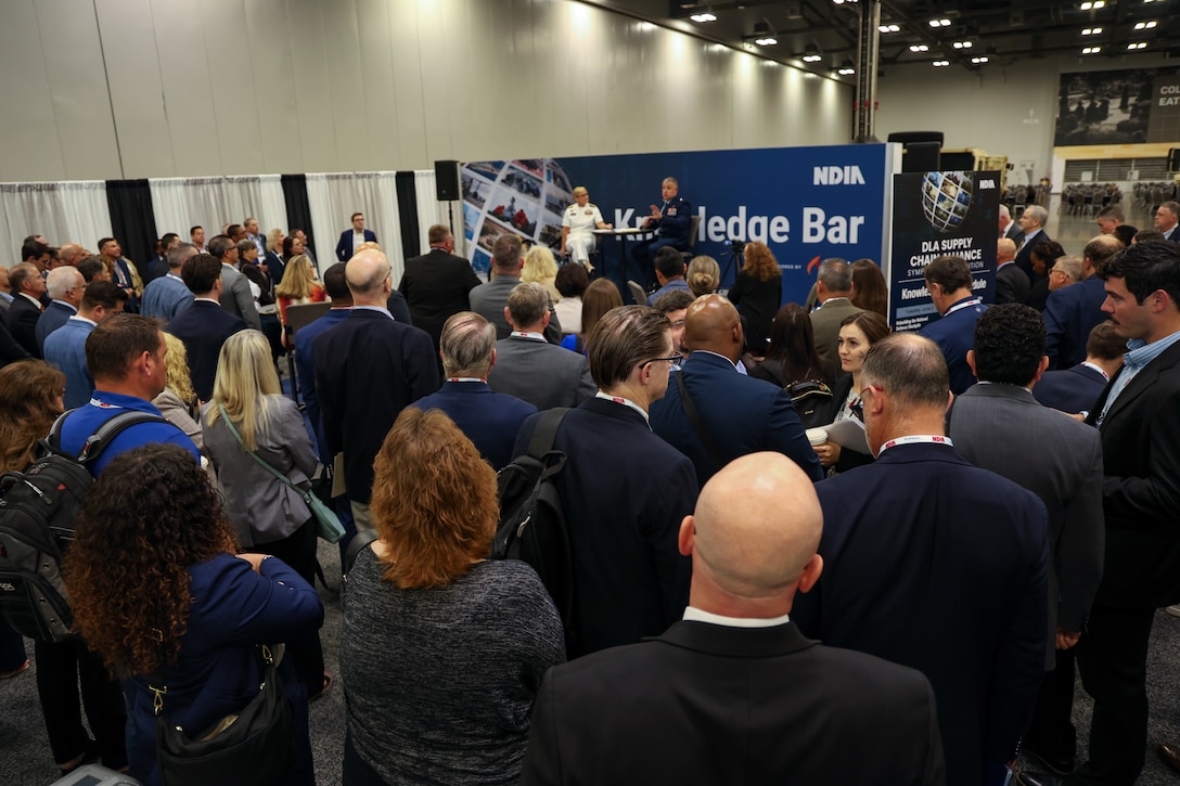 Defense Logistics Agency Weapons Support (Columbus) Commander Navy Rear Adm. Julie Treanor and DLA Weapons Support (Richmond) Commander Air Force Brig. Gen. Patrick Launey speak to industry June 2 at the DLA Supply Chain Alliance Symposium and Exhibition in Columbus, Ohio. The two leaders participated in a “Knowledge Bar” presentation where they updated industry partners on the progress of the integration of DLA Weapons Support. (Photo by Andrew Young/DLA)