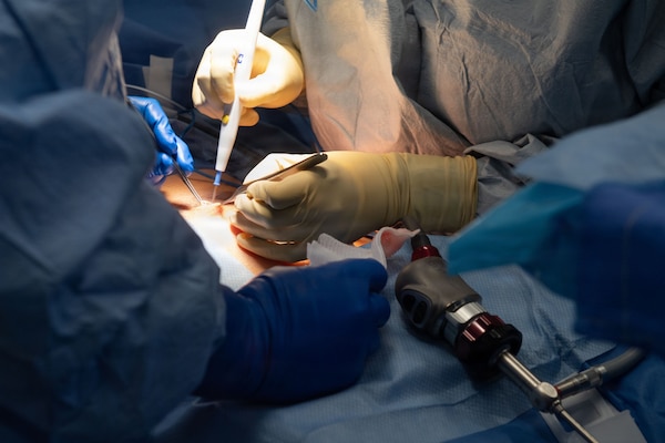 U.S. Navy Hospital Corpsman 3rd Class Nicholas Muller, left, assists Lt. Cmdr. Carina Felix, Ship’s Surgeon, while performing surgery aboard Nimitz-class aircraft carrier USS Dwight D. Eisenhower (CVN 69), June 22, 2026. Eisenhower is underway in the Atlantic Ocean conducting carrier qualifications, supporting East Coast Fleet Replacement Squadrons. (U.S. Navy photo by Mass Communication Specialist 3rd Class Evan Antonisse)