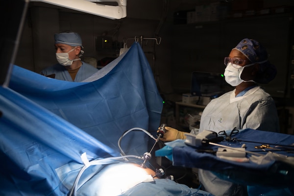 U.S. Navy Lt. Cmdr. Paul Kuhn, left, assists Lt. Cmdr. Carina Felix, Ship’s Surgeon, while performing surgery aboard Nimitz-class aircraft carrier USS Dwight D. Eisenhower (CVN 69), June 22, 2026. Eisenhower is underway in the Atlantic Ocean conducting carrier qualifications, supporting East Coast Fleet Replacement Squadrons. (U.S. Navy photo by Mass Communication Specialist 3rd Class Evan Antonisse)