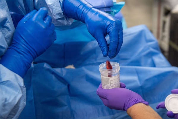 U.S. Navy Hospital Corpsman 3rd Class Nicholas Muller deposits surgical waste into a collection cup aboard Nimitz-class aircraft carrier USS Dwight D. Eisenhower (CVN 69), June 22, 2026. Eisenhower is underway in the Atlantic Ocean conducting carrier qualifications, supporting East Coast Fleet Replacement Squadrons. (U.S. Navy photo by Mass Communication Specialist 3rd Class Evan Antonisse)