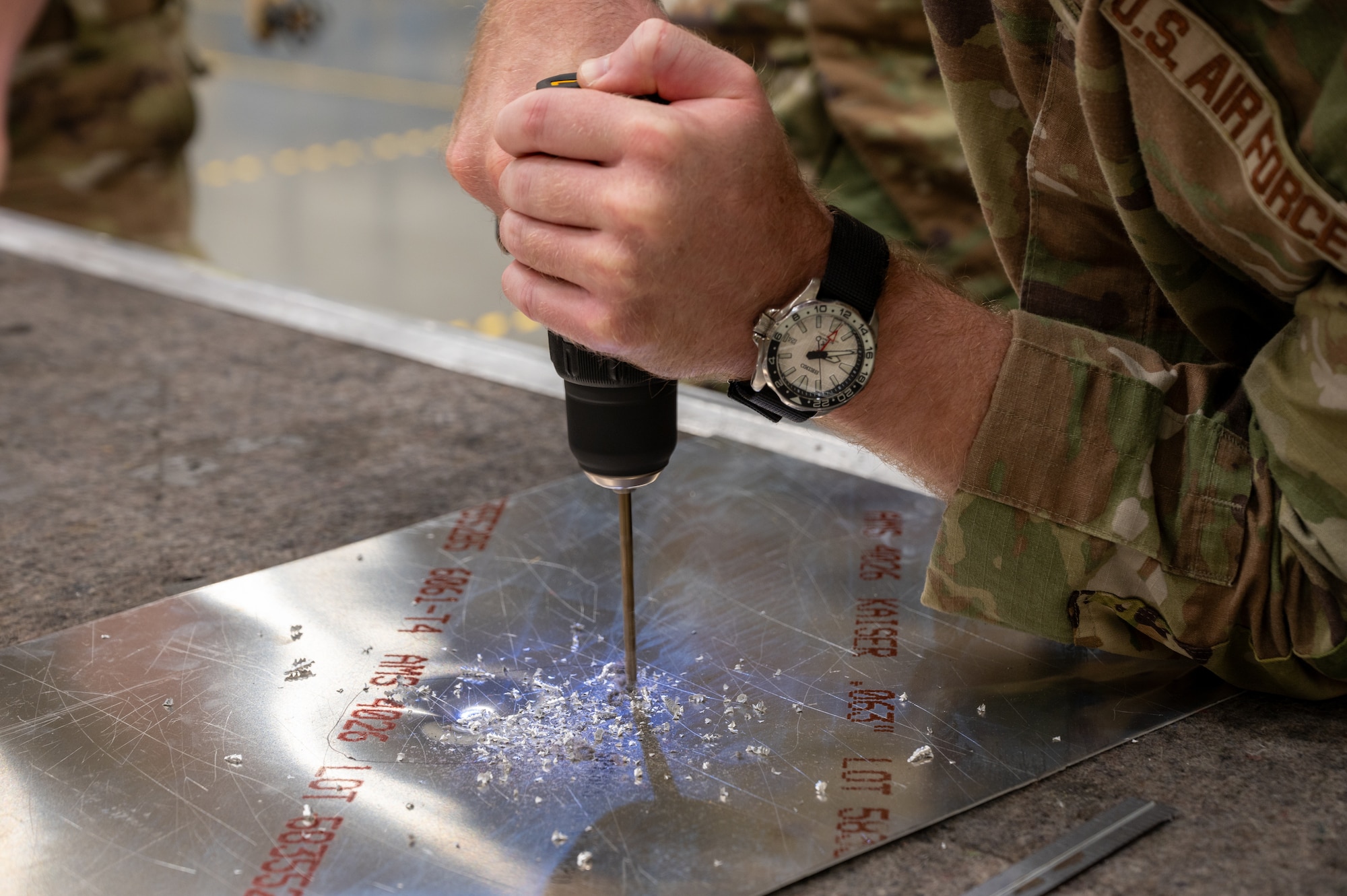 A U.S. Air Force Airman drills a hole into sheet metal as part of the Aircraft Battle Damage Evaluator course at Joint Base McGuire-Dix-Lakehurst, N.J., June 24, 2026.
