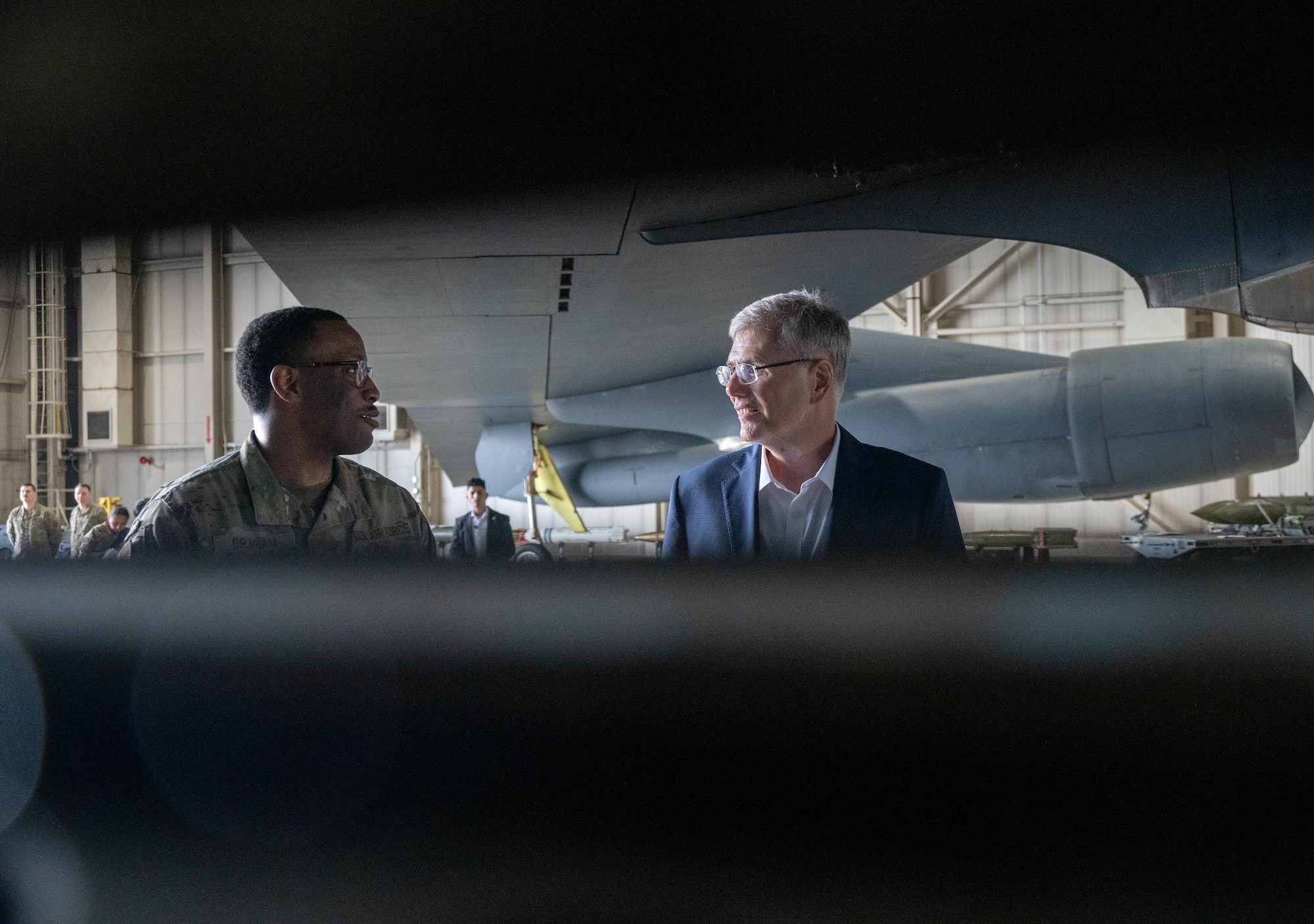 U.S. Air Force Tech. Sgt. Giftcent Graham, assigned to the 69th Bomber Generation Squadron, briefs Secretary of the Air Force Troy Meink about the B-52H Stratofortress during a visit at Minot Air Force Base, North Dakota, June 29, 2026. Among other advances, the B-52H will be upgraded with new engines that will improve their performance and change their designation to B-52J. (U.S. Air Force photo by Senior Airman Wesley Davies)