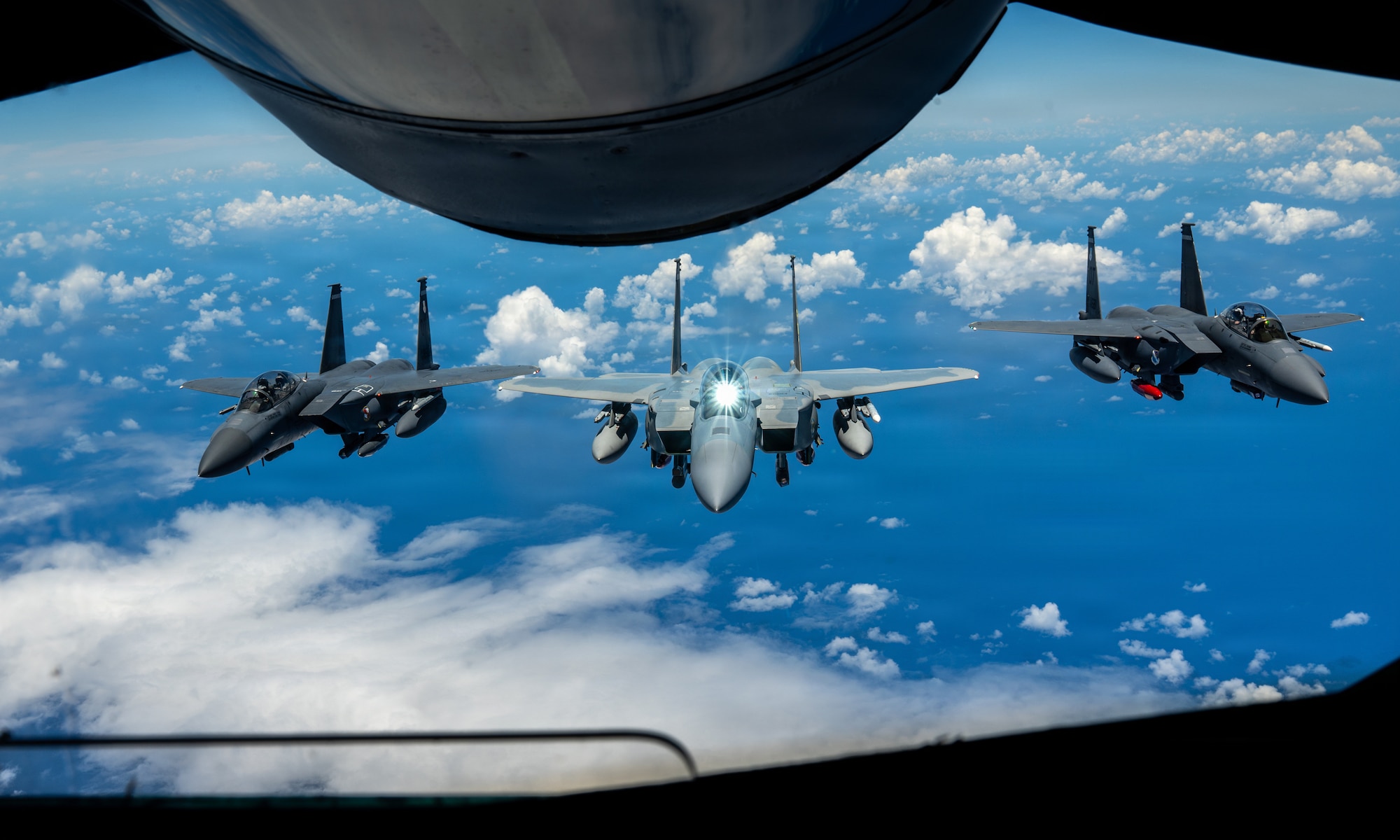 A U.S. Air Force F-15EX Eagle II and F-15E Strike Eagles assigned to the 85th Test and Evaluation Squadron, Eglin Air Force Base, Florida, fly in formation after receiving fuel from a KC-135 Stratotanker assigned to the 909th Air Refueling Squadron over the Pacific Ocean, June 29, 2026.